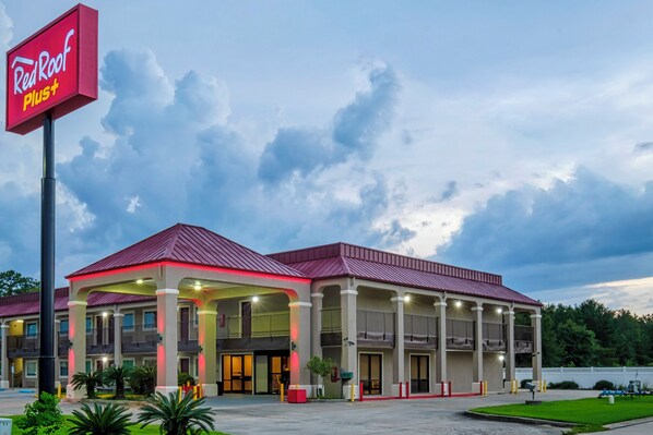 A Red Roof Plus hotel with a covered parking area and a large sign. - Red Roof Inn PLUS+ Hammond (Hammond)
