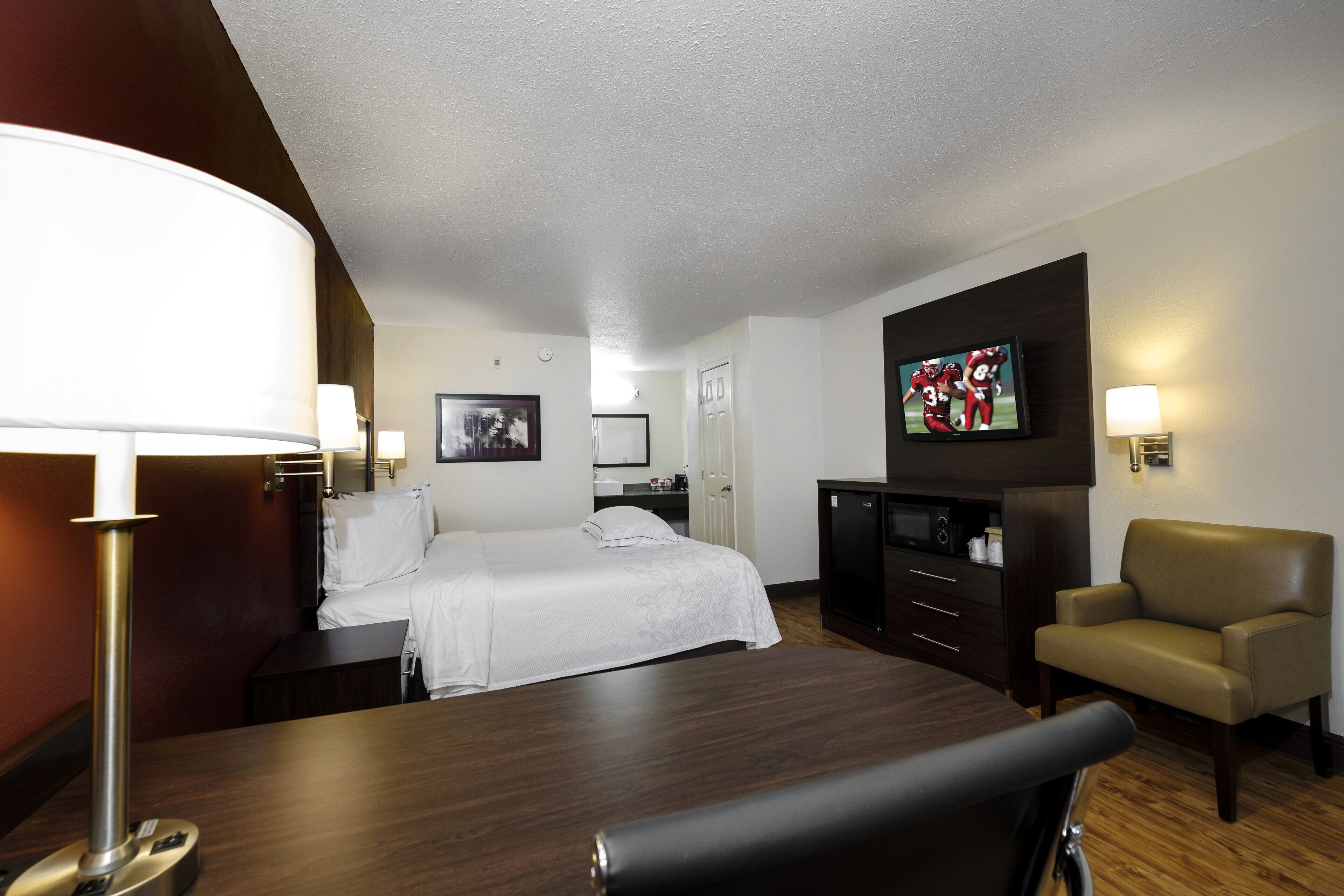 premium room, 1 king bed (upgraded bedding & snack, smoke free) | desk, laptop workspace, blackout curtains, iron/ironing board