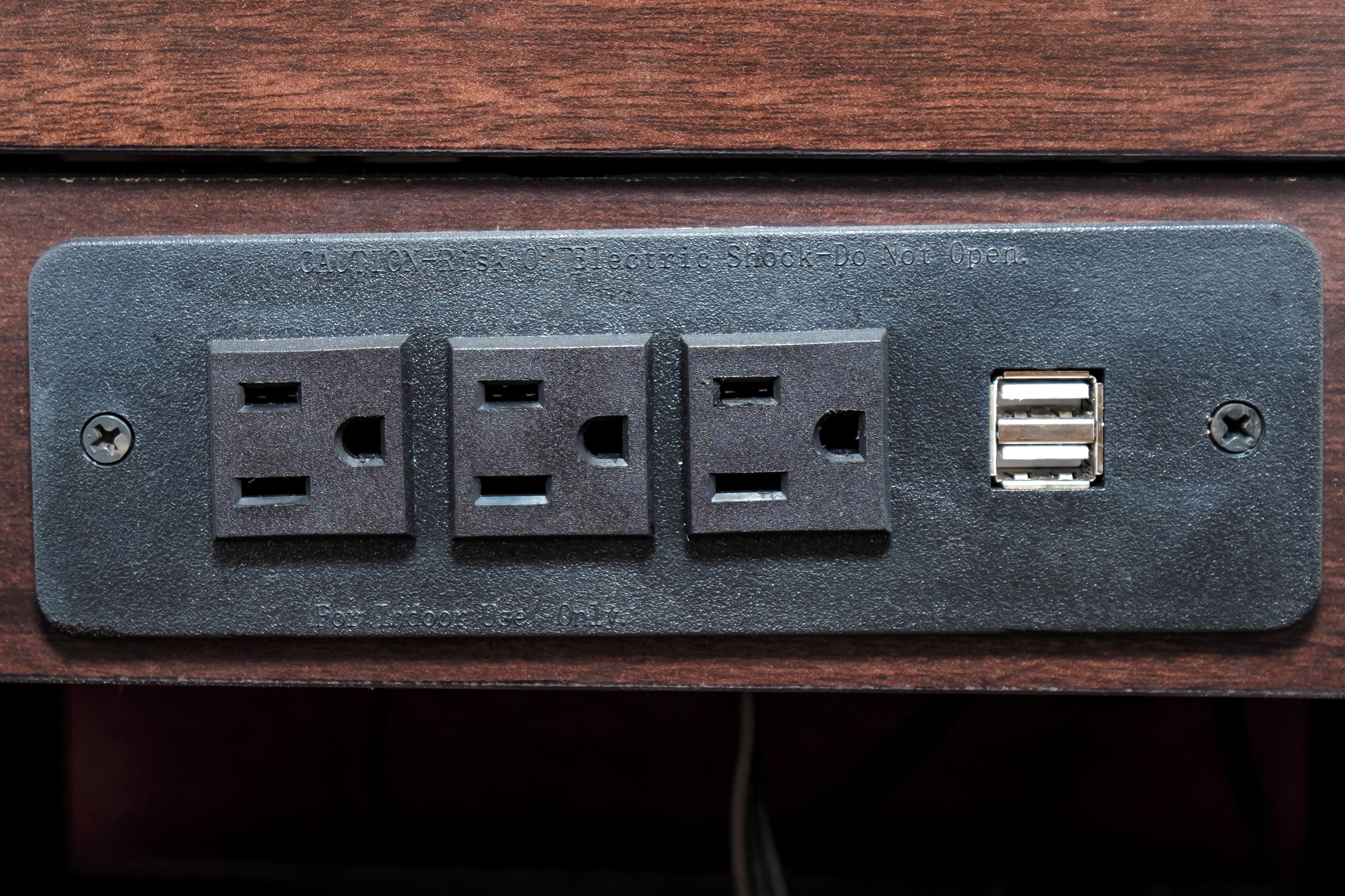 A power outlet with three sockets and a USB port.