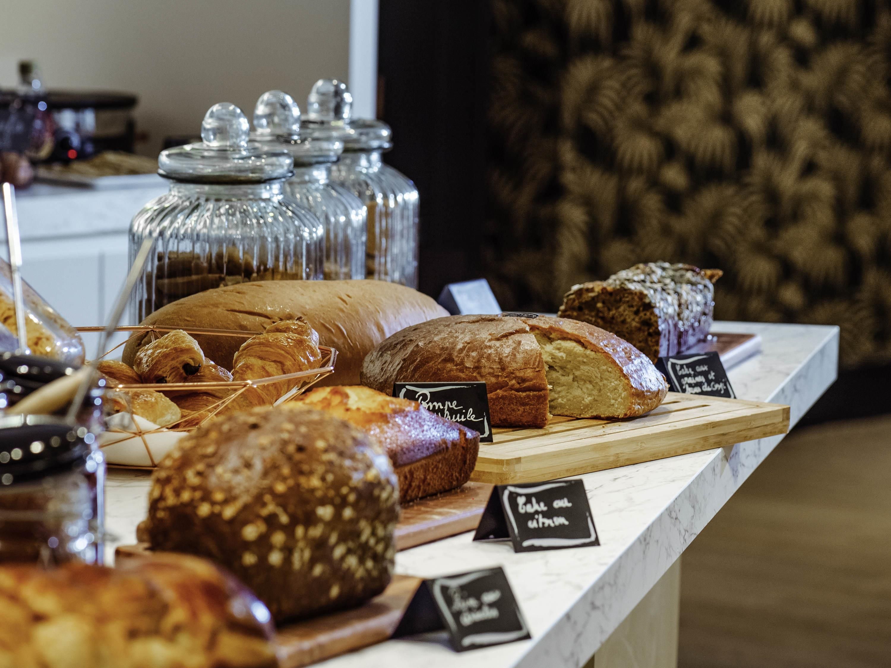 A bakery display with various breads and pastries.