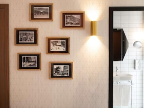 Un baño con lavamanos, espejo y perchero para toallas.