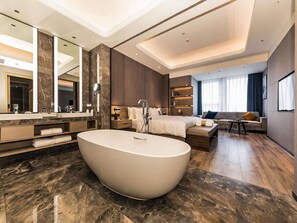 A modern hotel bathroom with a large freestanding bathtub, a double sink vanity, and a large mirror. - Mercure Xian Hi Tech Zone (Xi'an)
