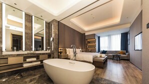 A modern bathroom with a large freestanding bathtub, a vanity with a mirror, and a shower area. - Mercure Xian Hi Tech Zone (Xi'an)