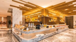 A modern hotel lobby with a marble reception desk, wooden paneling, and a well-lit interior. - Mercure Xian Hi Tech Zone (Xi'an)