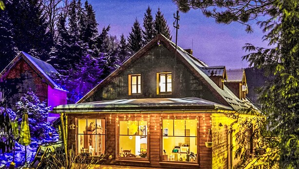 A cabin with a sloped roof, two visible windows, and a front porch with string lights. - Karpacz Kowary by Interhome (Karpacz)