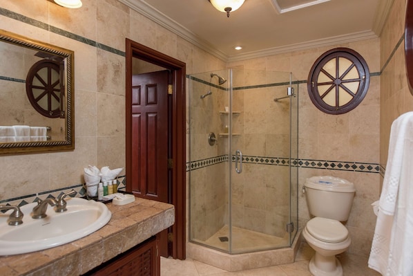 A bathroom with a glass-enclosed shower, a white sink, and a toilet. - Hilton Grand Vacations Club The Crane Barbados (Diamond Valley)