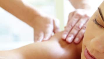 A close-up of a massage being performed on a person's back.