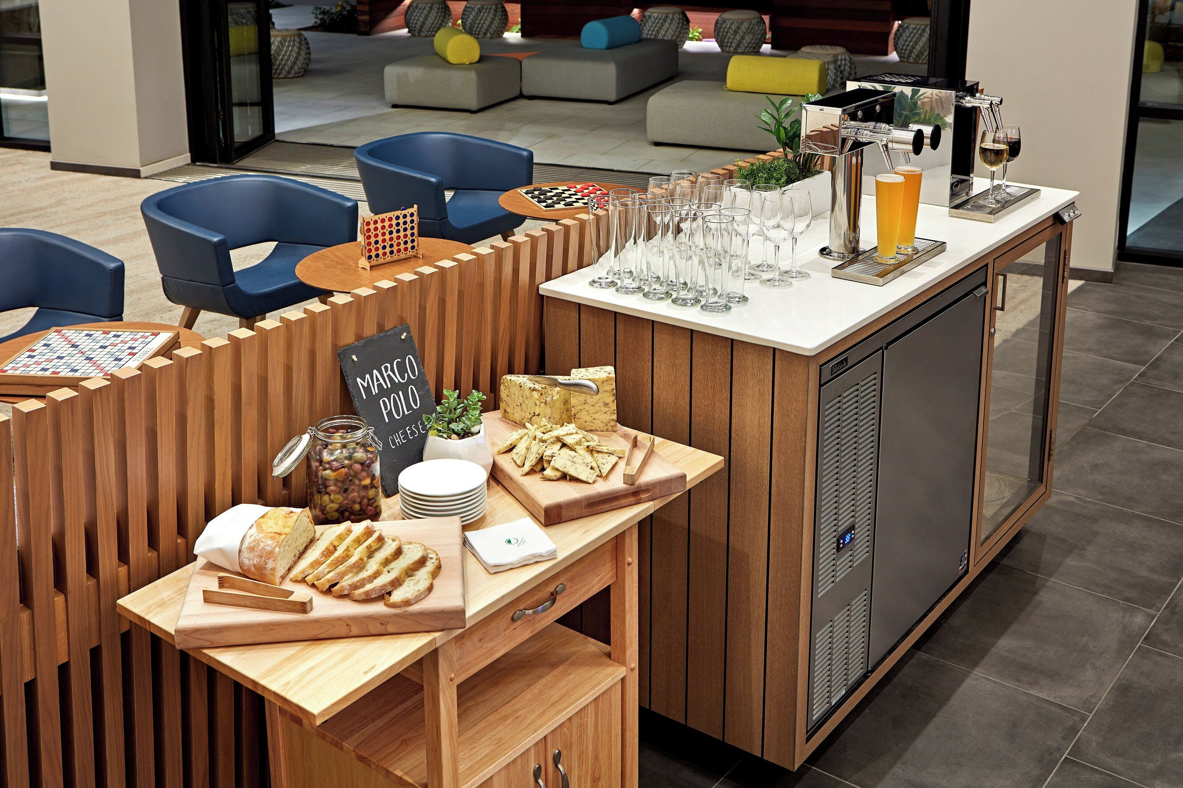 A breakfast bar with a coffee machine, glasses, and snacks.