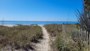 A sandy path leading to a beach with a wooden fence on one side. - Family Friendly, Easy Beach Access Across the Street! (St. George Island)