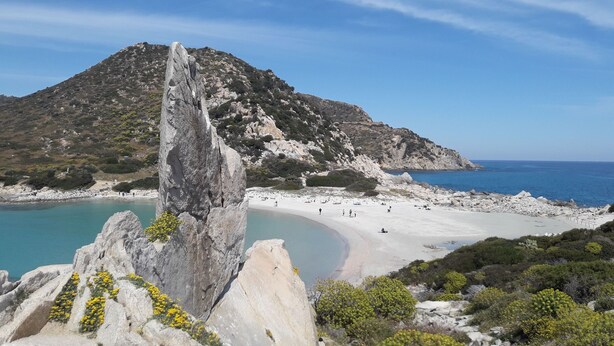 A coastal landscape with a prominent rock formation, a sandy beach, and a clear view of the sea. - VILLASIMIUS CENTRO HOLIDAY HOUSE (Villasimius)
