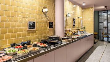 A buffet with various food options and signs indicating dietary preferences.