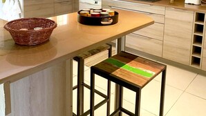 A modern kitchen with a central island, a gas stove, and a large window. - Beautiful Provencal villa of charm with beautiful views of village and castle (Villeneuve-Loubet)