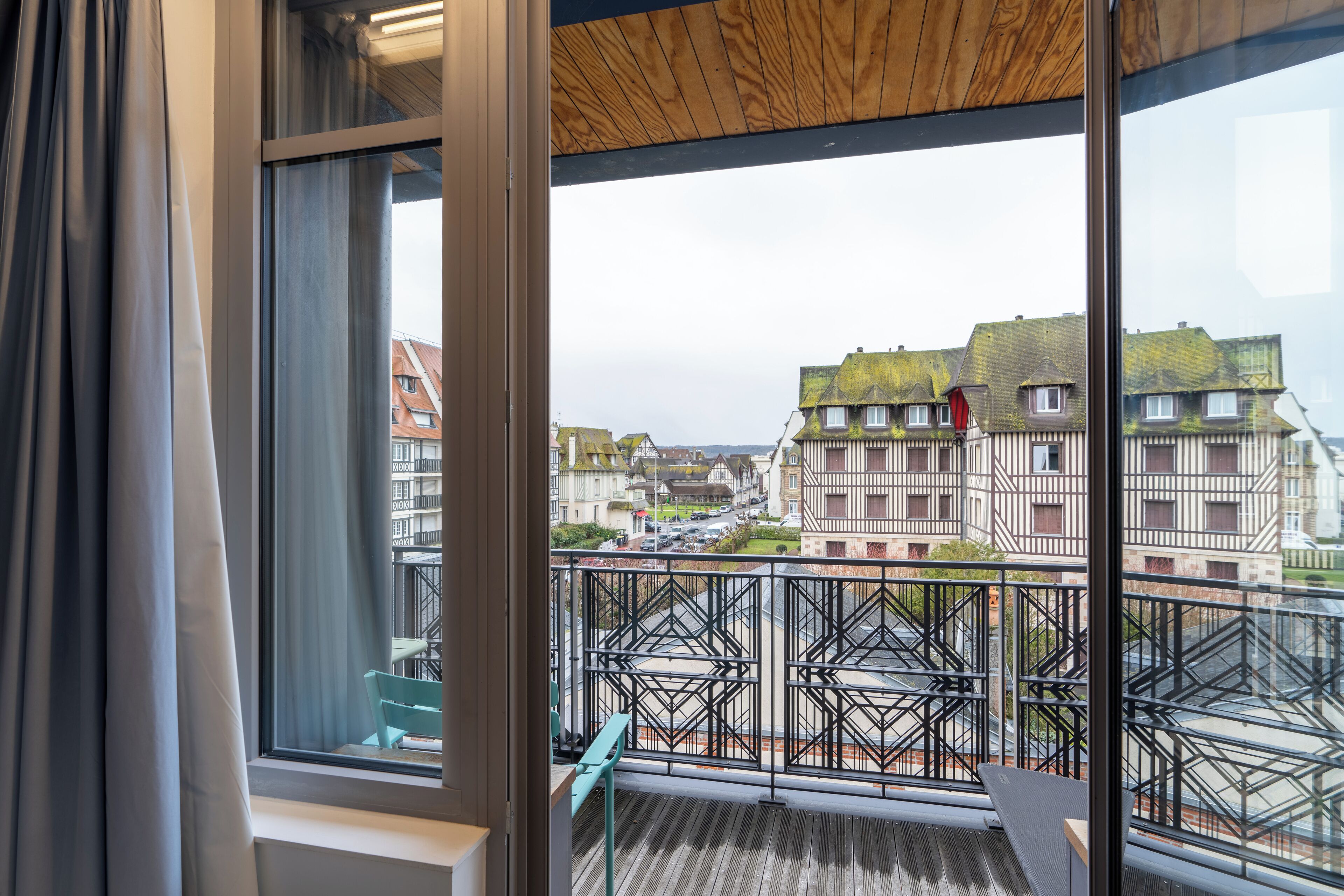 A balcony with a view of buildings and a street.