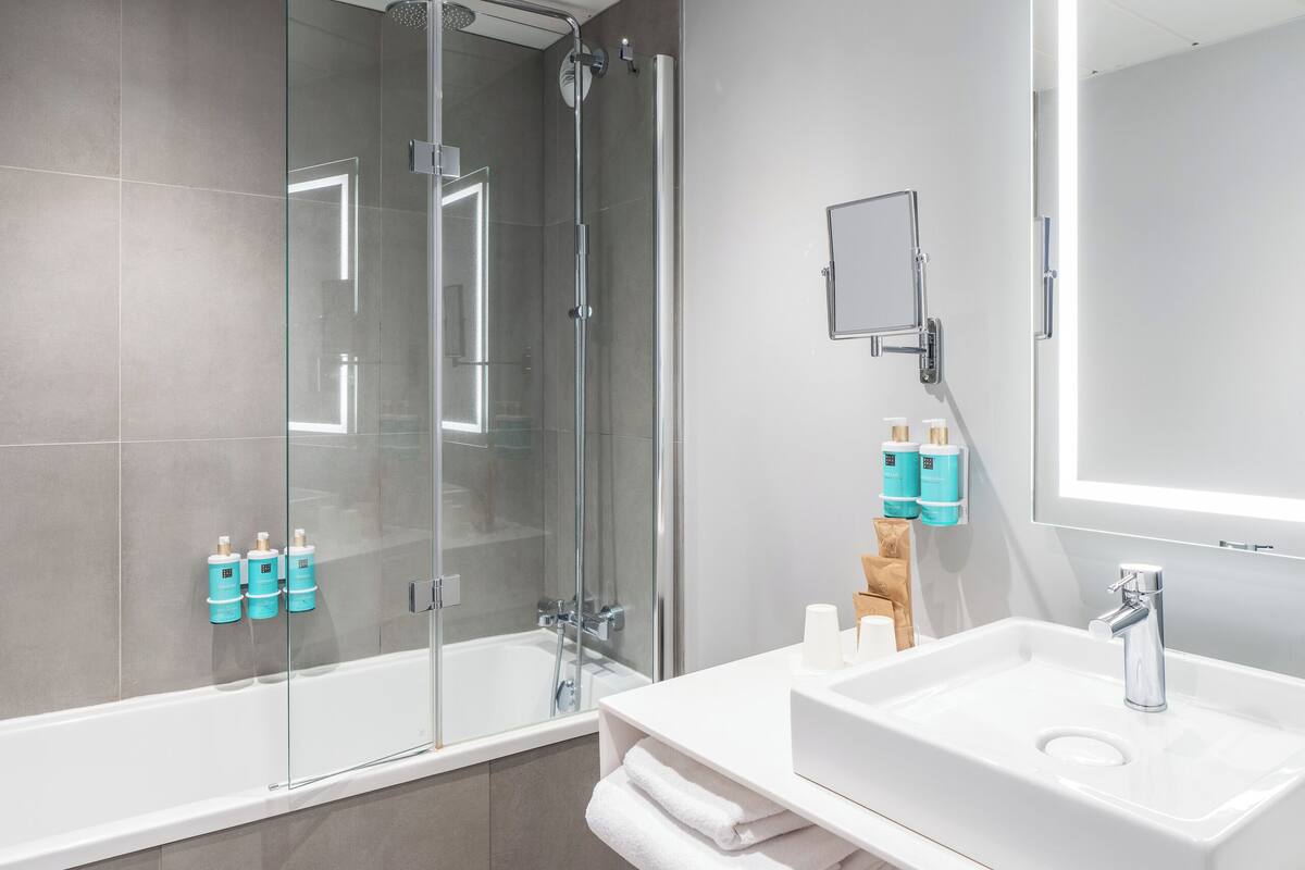 eco-friendly toiletries, hair dryer, slippers, towels