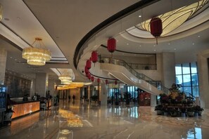 A spacious lobby with a reception desk, a staircase, and a large window. - Jingcheng International Hotel (Yangzhou)