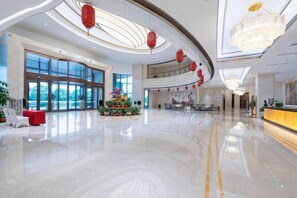 A spacious lobby with a reception desk, seating area, and large windows. - Jingcheng International Hotel (Yangzhou)