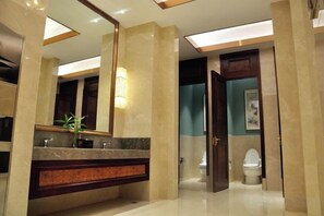 A modern bathroom with a marble vanity, a large mirror, and a separate toilet area. - Jingcheng International Hotel (Yangzhou)