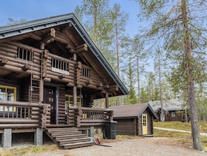 A log cabin with a porch, a small attached structure, and a clear sky. - Riekonmarja by Interhome (Äkäslompolo)