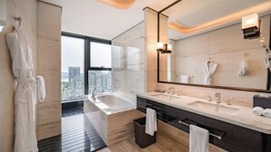 A modern bathroom with a large bathtub, dual sinks, and a large mirror. - voco Hangzhou Binjiang Minghao by IHG (Hangzhou)
