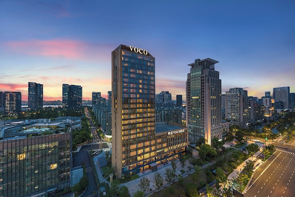 A high-rise building with the name "VOCO" prominently displayed at the top.