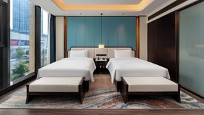 A modern hotel room with a large bed, two bedside tables, a nightstand, and a view of the city. - voco Hangzhou Binjiang Minghao by IHG (Hangzhou)