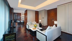 A spacious hotel lobby with a modern design, featuring a seating area with sofas and a coffee table, a reception desk, and a view of the hallway. - voco Hangzhou Binjiang Minghao by IHG (Hangzhou)