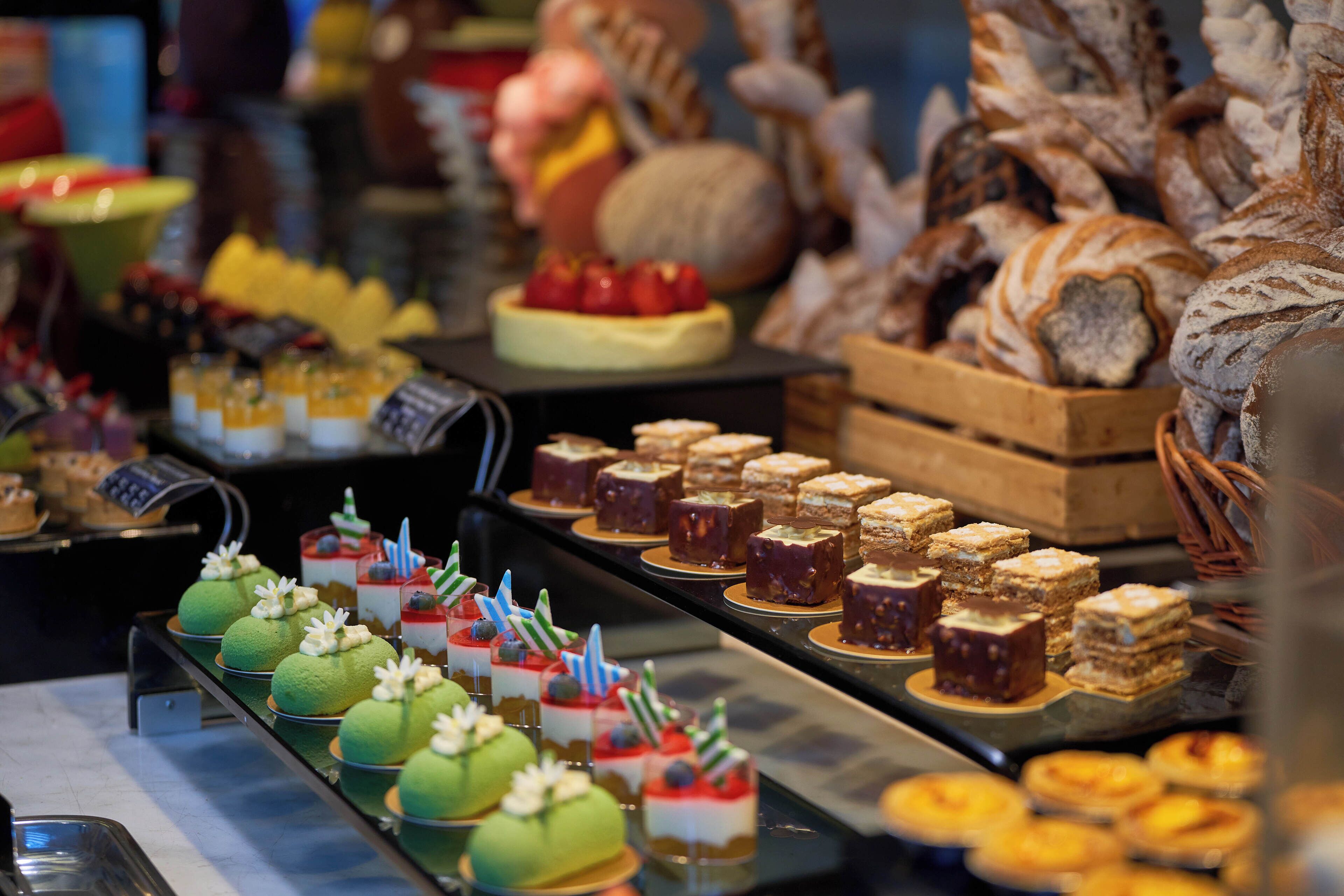 A variety of desserts and pastries displayed in a buffet setting.