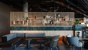 A modern lounge area with a sectional sofa, round tables, and contemporary chairs. - Comfort Hotel Arlanda Airport Terminal (Arlanda)