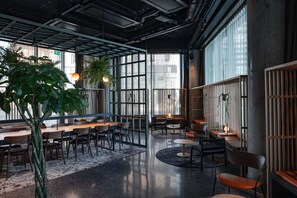 A modern interior with high ceilings, exposed ductwork, and large windows. - Comfort Hotel Arlanda Airport Terminal (Arlanda)