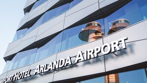 A modern building with a sign reading "Comfort Hotel Arlanda Airport".