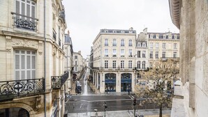 A street view with buildings, a bicycle, and a pedestrian walkway. - Bright and comfortable apartment - 2nd FLOOR (BORDEAUX)