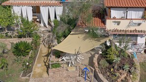 An aerial view of a residential property with a patio area, outdoor furniture, and a variety of plants. - Casetta Ale 20 mt from the sea (Tancau Sul Mare)