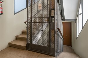 A staircase with a metal gate leading to a room.