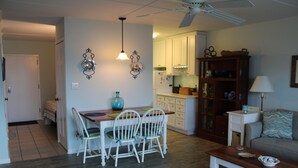 A compact living space with a dining area, kitchen, and seating area. - Beautiful Condo! Ocean Block & View! (Rehoboth Beach)