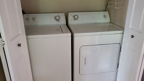 A laundry room with two stacked washers and dryers. - Fisherman, Traveling Workers and Vactioners love the Barefoot Retreat (Eddyville)