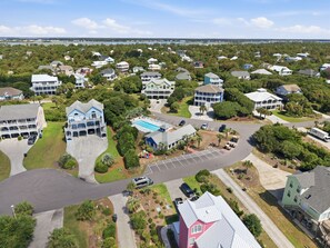 A residential area with houses, a swimming pool, and a parking lot. - Handicap Friendly,golf cart,community pool,easy beach access,Spinnaker's Reach (Emerald Isle)