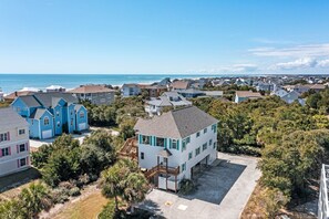 A residential area with houses, a beach, and a clear sky. - 3rd Row Oceanview Duplex,beach and community pool access, in Spinnaker's Reach (Emerald Isle)