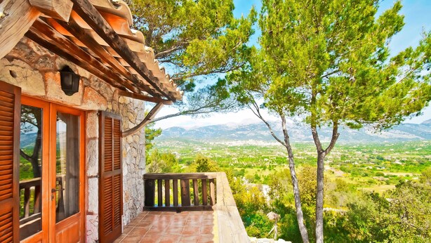 A stone building with a wooden balcony overlooking a mountainous landscape. - SON DURI (CIMENTERES) - Villa with private pool in Inca. Free WiFi (Selva)