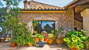 A stone building with an arched doorway, surrounded by various potted plants. - SON DURI (CIMENTERES) - Villa with private pool in Inca. Free WiFi (Selva)