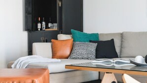 Una sala moderna con un sofá, una mesa de centro y una estantería.