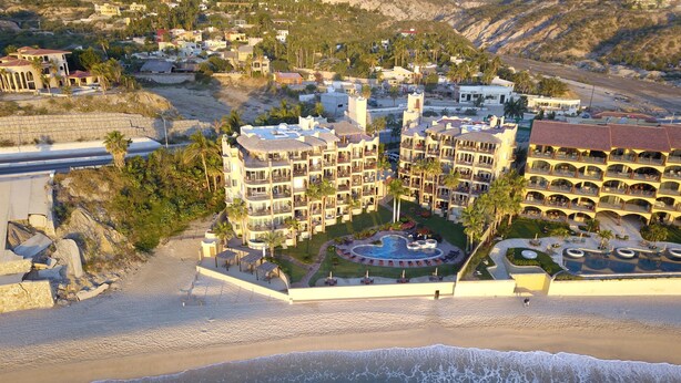 A coastal hotel with multiple buildings, a central pool area, and a beach. - Las Olas A104 3 BR by Casago (San José del Cabo)