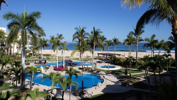 A resort with multiple swimming pools, palm trees, and a beach view. - Las Mananitas C308 3 BR by Casago (San José del Cabo)