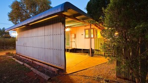 A single-story metal building with a corrugated roof, a small porch, and a door leading inside. - 10 Tautog Street - Great Family space in central location (EXMOUTH)