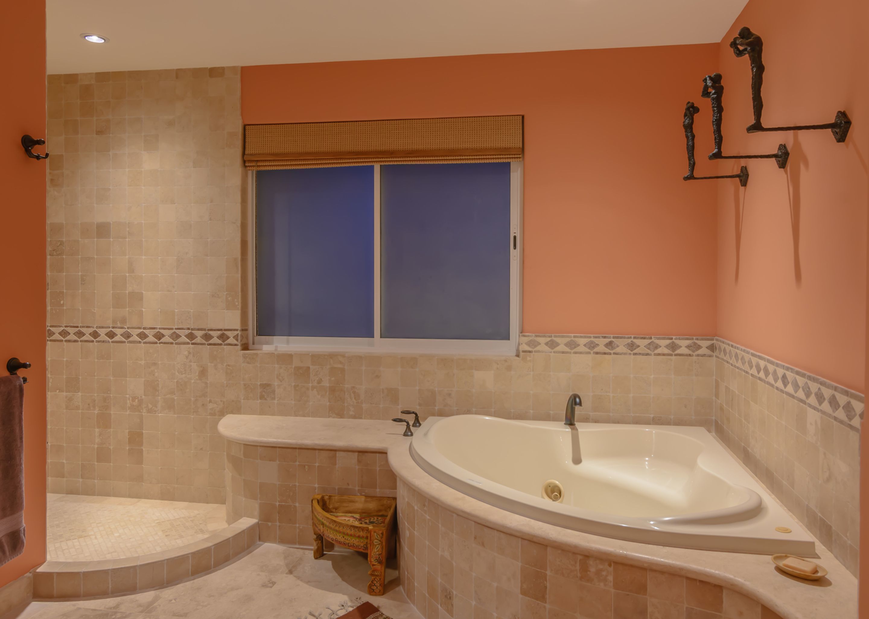 A bathroom with a bathtub, a shower, and a window.