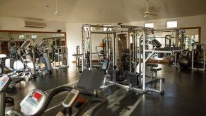 A gym with various exercise equipment, including treadmills, weight machines, and free weights. - Las Mananitas E3301 2 BR by Casago (San José del Cabo)