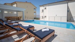 A poolside area with sun loungers and a pool. - Apartment Josipa by Interhome (Novi Vinodolski/Klenovica)