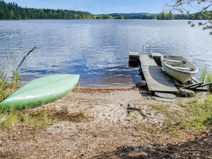 A calm lake with a dock and a boat. - Kanerva by Interhome (Juuka)