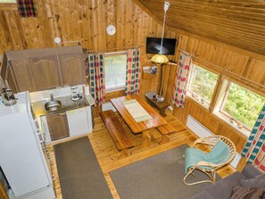 A compact cabin with a kitchen, dining area, and a cozy seating space. - Kanerva by Interhome (Juuka)