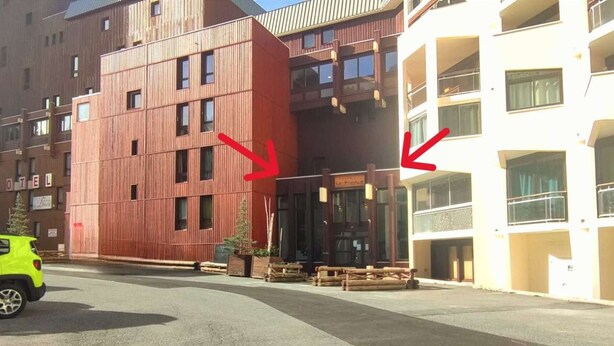 A hotel with a modern design, featuring a large wooden facade and a white building with balconies. - Beautiful comfortable apartment at the foot of the slopes with internet (Isola 2000)