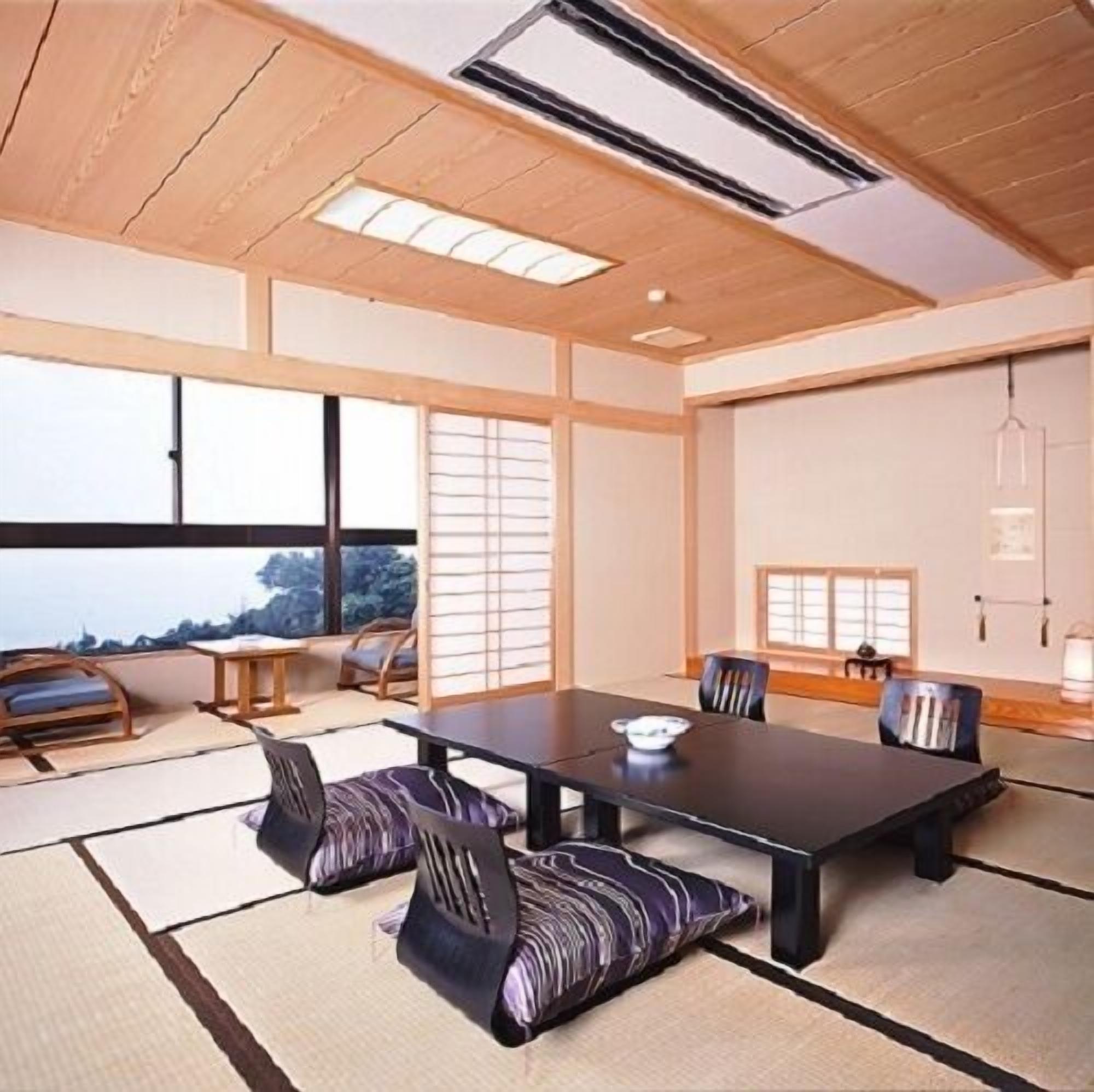 A traditional Japanese-style room with tatami flooring, a low table, and shoji screens.